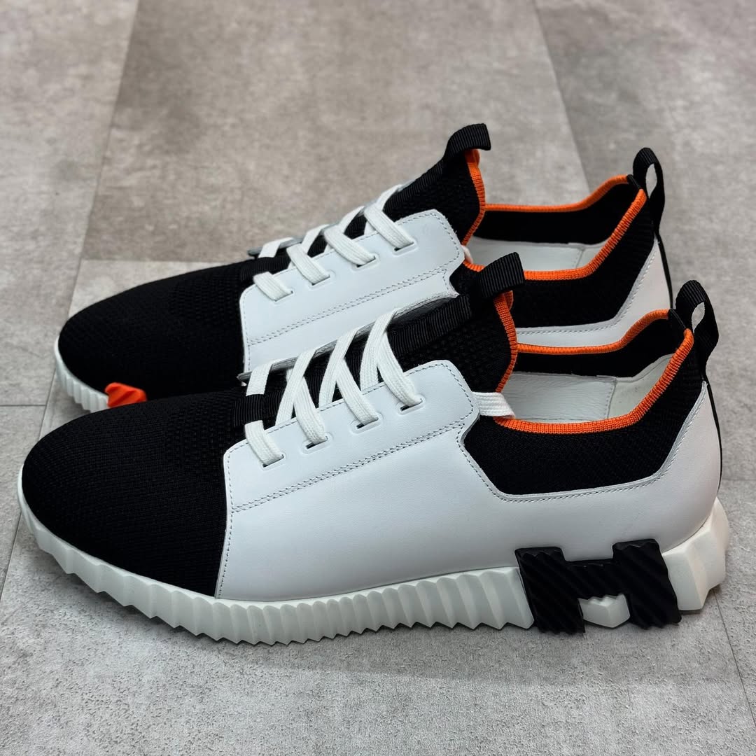 Hermés Depart Slip-On Sneaker in White Knit and Calfskin with a Black and Orange Rubber Sole